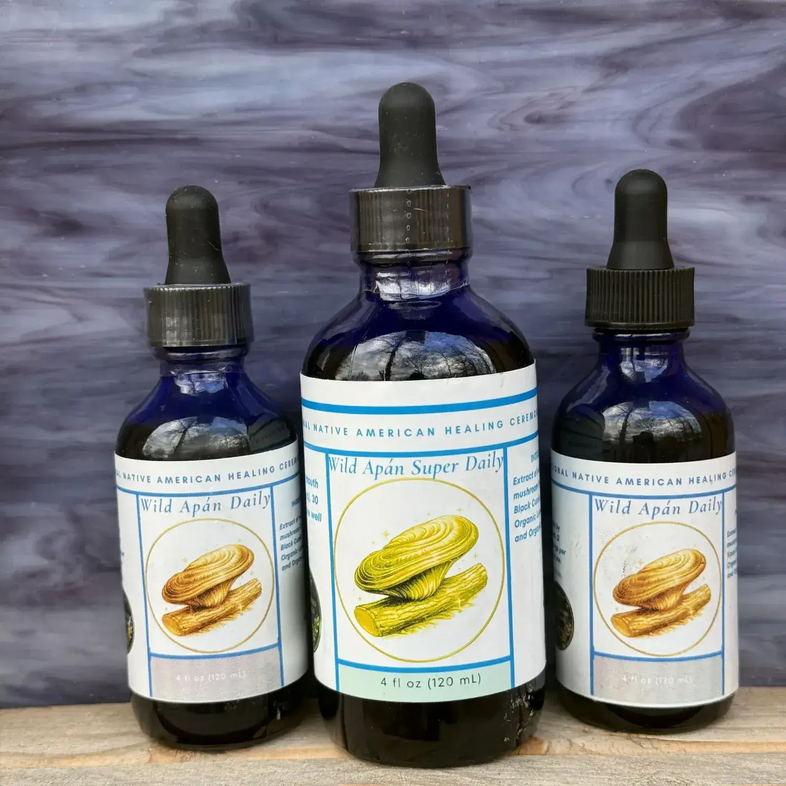 Wild Apán mushroom supplement bottles in a natural forest setting